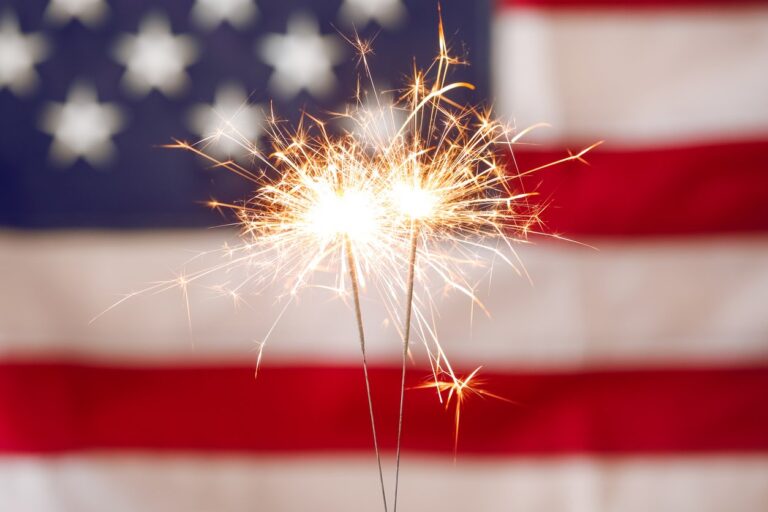 sparkler fireworks in front of the American flag